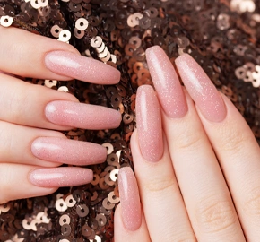Female hands with beautiful manicure sequins background